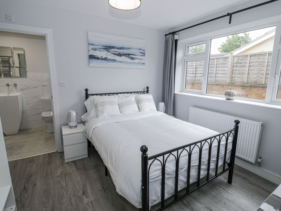 A bedroom with a bed and a window at Chillon South Littleton near Honeybourne