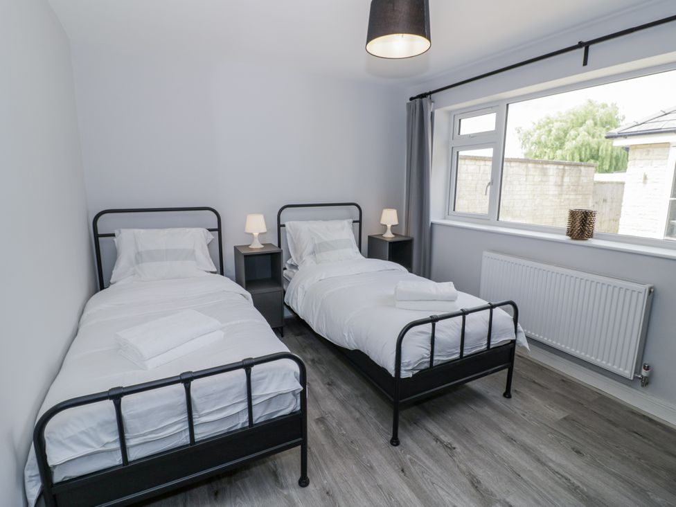 A bedroom with two beds and a window at Chillon in South Littleton near Honeybourne
