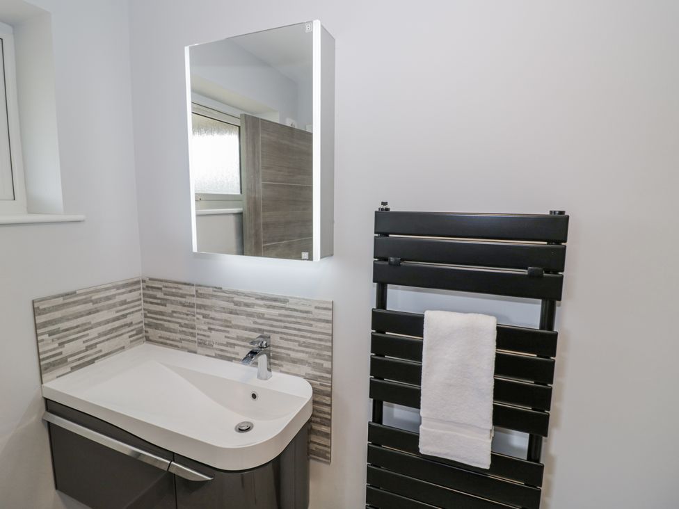 A bathroom with a sink and towel radiator at Chillon South Littleton near Honeybourne