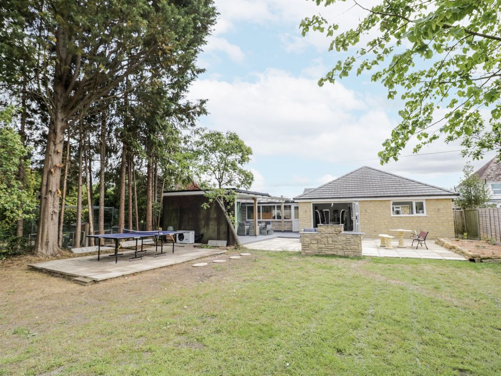 A garden with a table tennis table and a house at Chillon South Littleton near Honeybourne