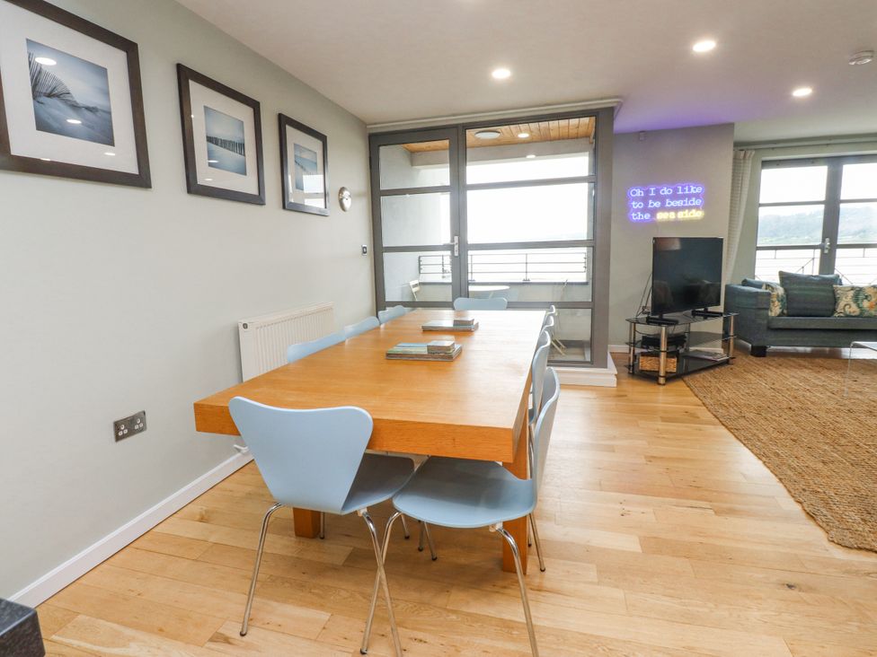 A dining room with a table and chairs at 2 The Quay in Pentraeth