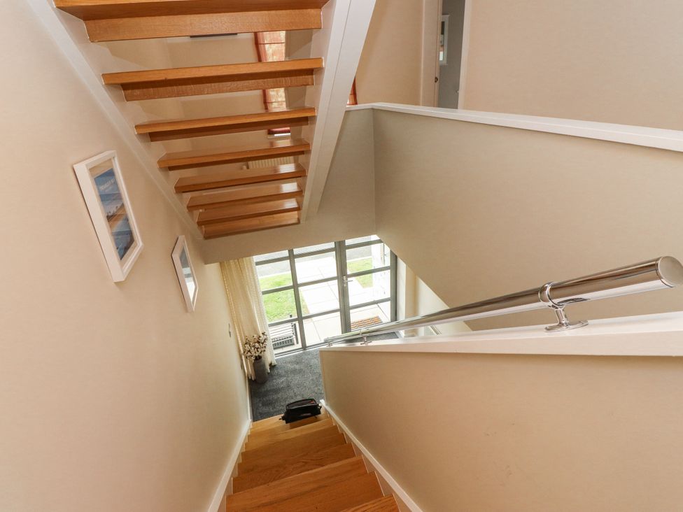 A staircase with wooden steps and a railing at 2 The Quay Pentraeth