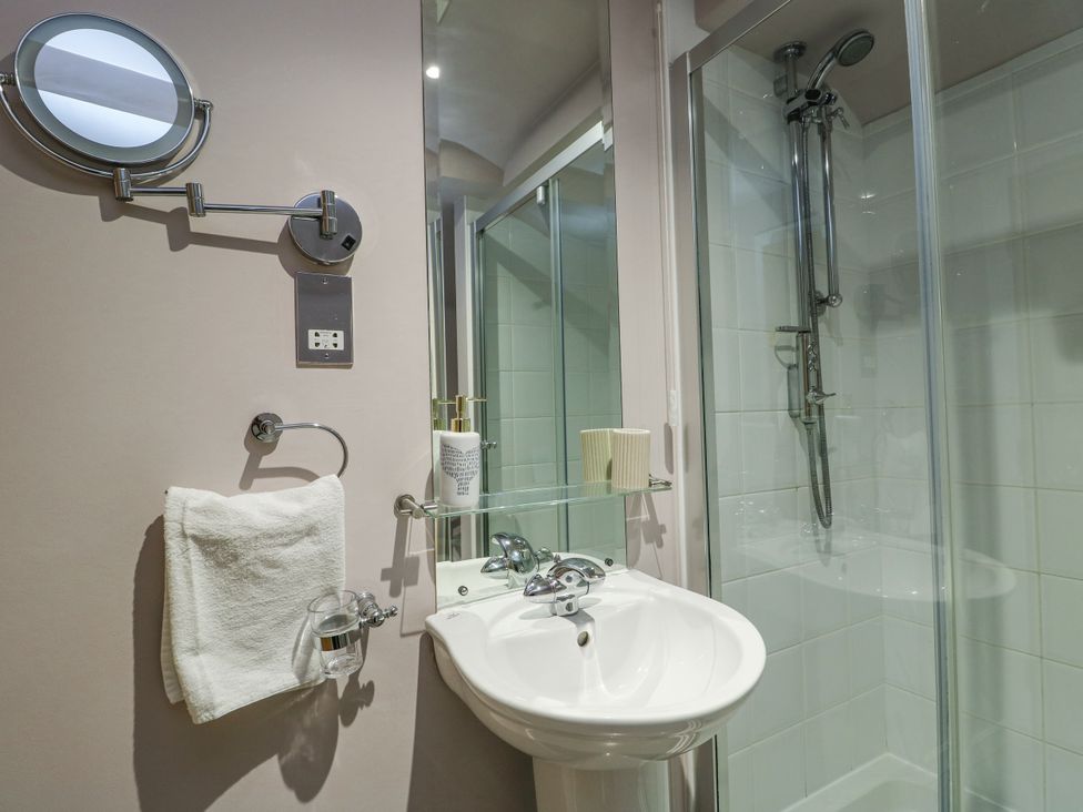 A bathroom with a sink and shower at 2 The Quay Pentraeth