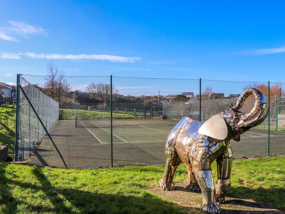 An elephant sculpture beside a tennis court at The Black Barnacle Portreath
