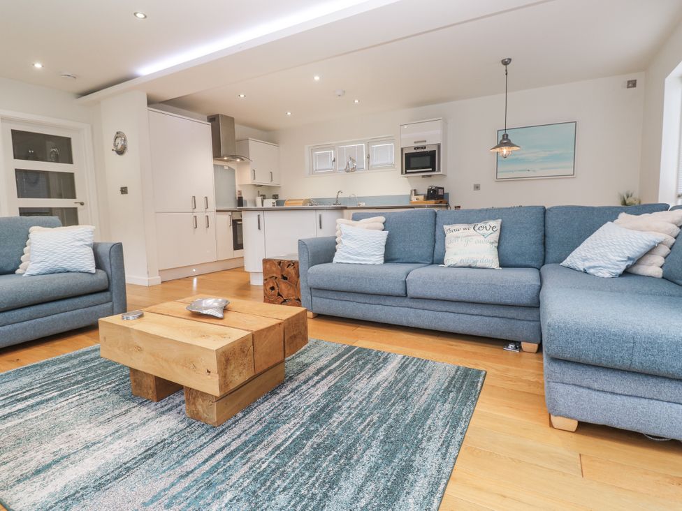 A living room with a sofa and coffee table at The Black Barnacle in Portreath