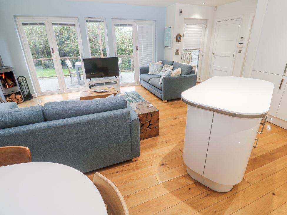 A living room with a sofa and television at The Black Barnacle in Portreath