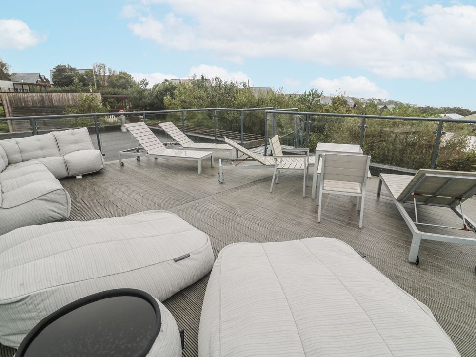 An outdoor terrace with bean bags and sun loungers at The Black Barnacle Portreath