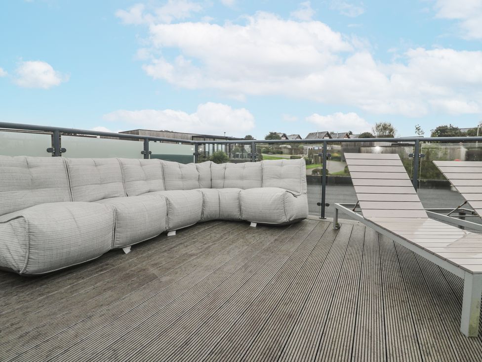An outdoor space with a sofa and sun loungers at The Black Barnacle Portreath