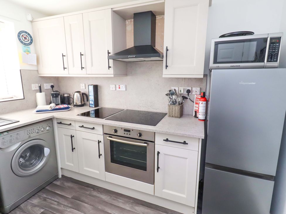 A kitchen with appliances and fixtures at Sea Shore in Seahouses
