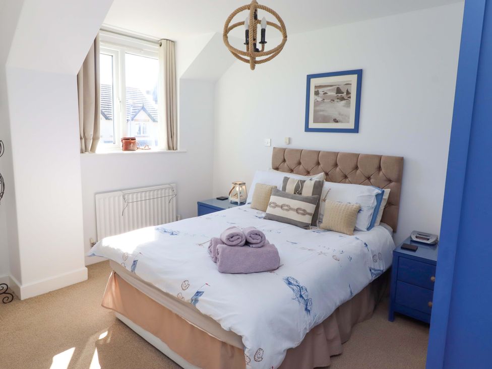 A bedroom with a bed and bedside table at Sea Shore in Seahouses