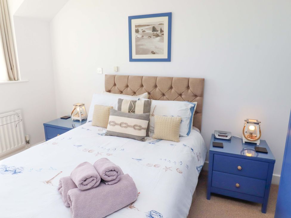 A bedroom with a bed and bedside tables at Sea Shore in Seahouses