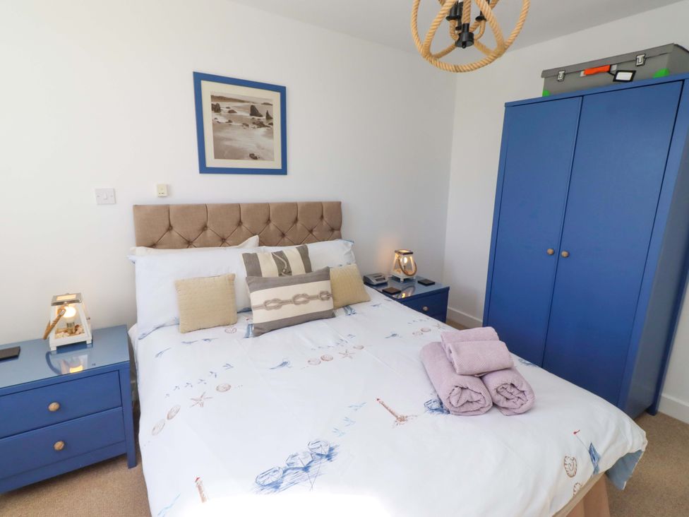 A bedroom with a bed and a wardrobe at Sea Shore in Seahouses