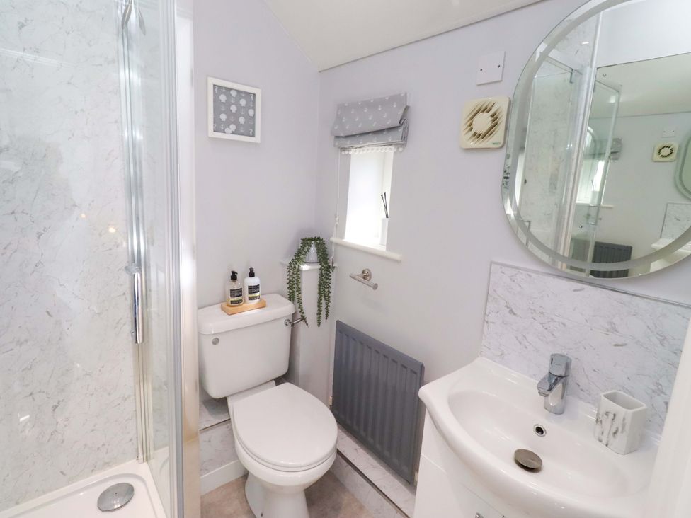 A bathroom with a shower and toilet at Sea Shore in Seahouses