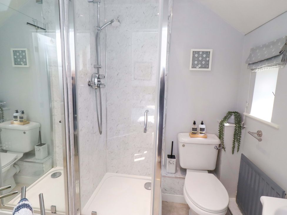 A bathroom with a shower and toilet at Sea Shore in Seahouses
