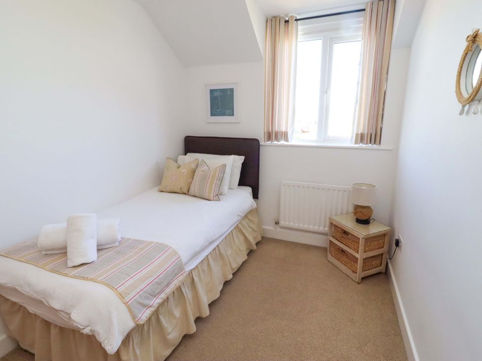 A bedroom with a single bed and lamp at Sea Shore in Seahouses