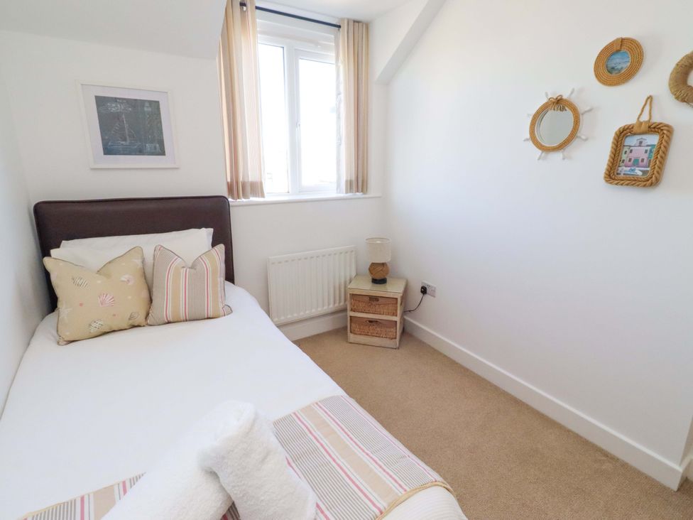 A bedroom with a single bed and nightstand at Sea Shore in Seahouses