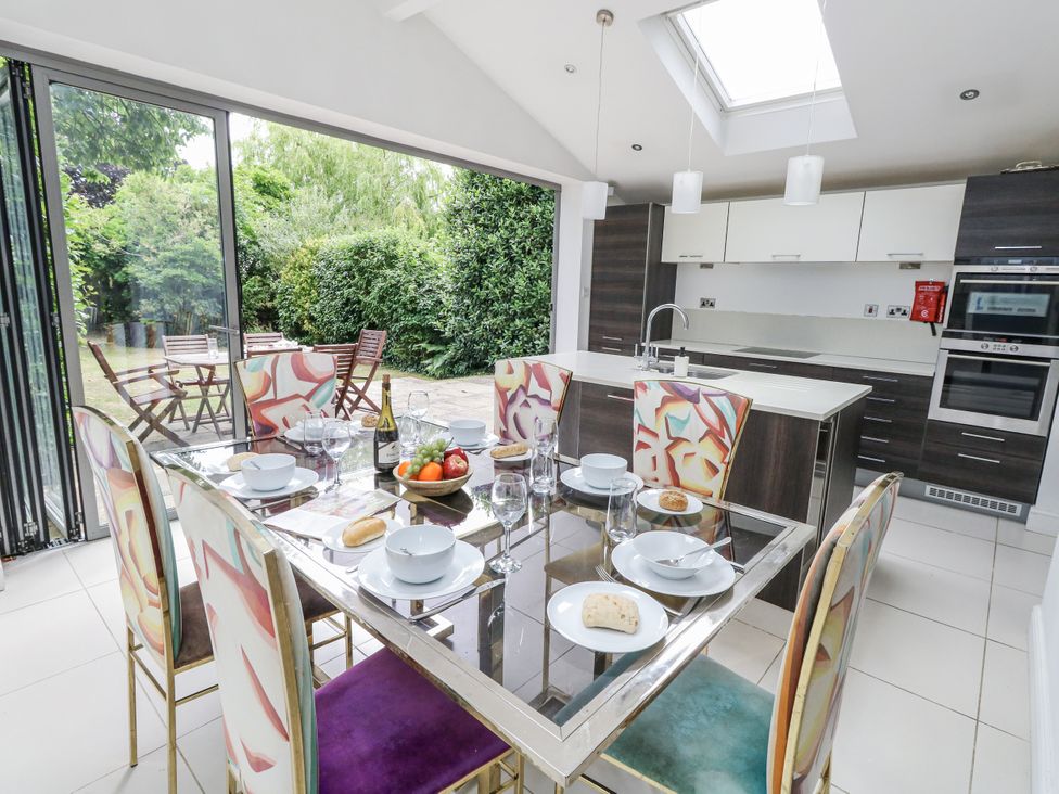 A dining room with a table set for a meal at King Henry House in Lymington