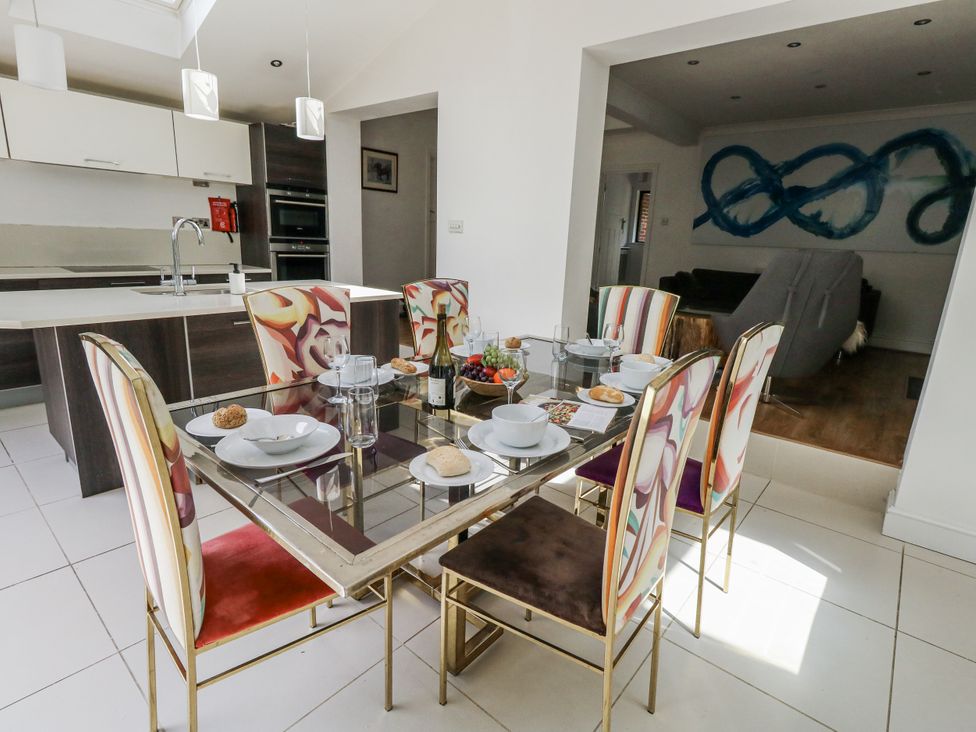 A dining room with a table set for a meal at King Henry House in Lymington