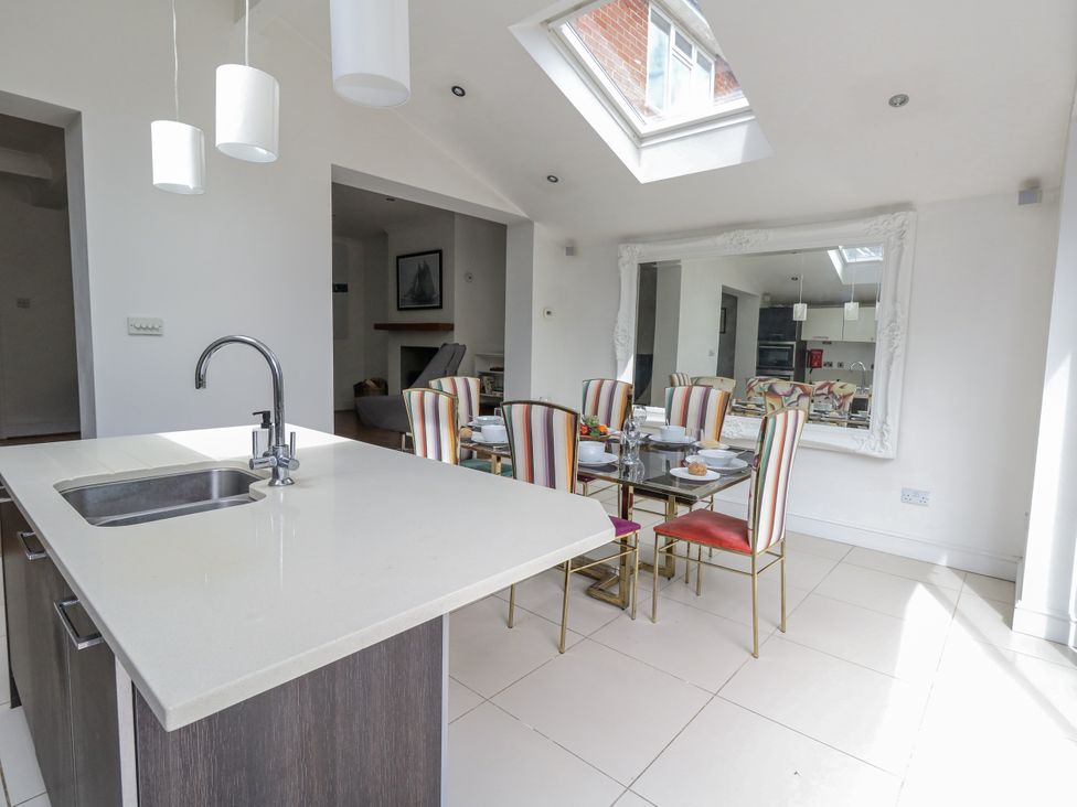 A dining room with a table and chairs at King Henry House in Lymington