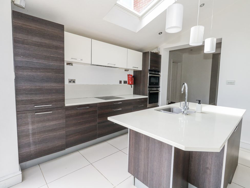 A kitchen with cabinets and a countertop at King Henry House in Lymington