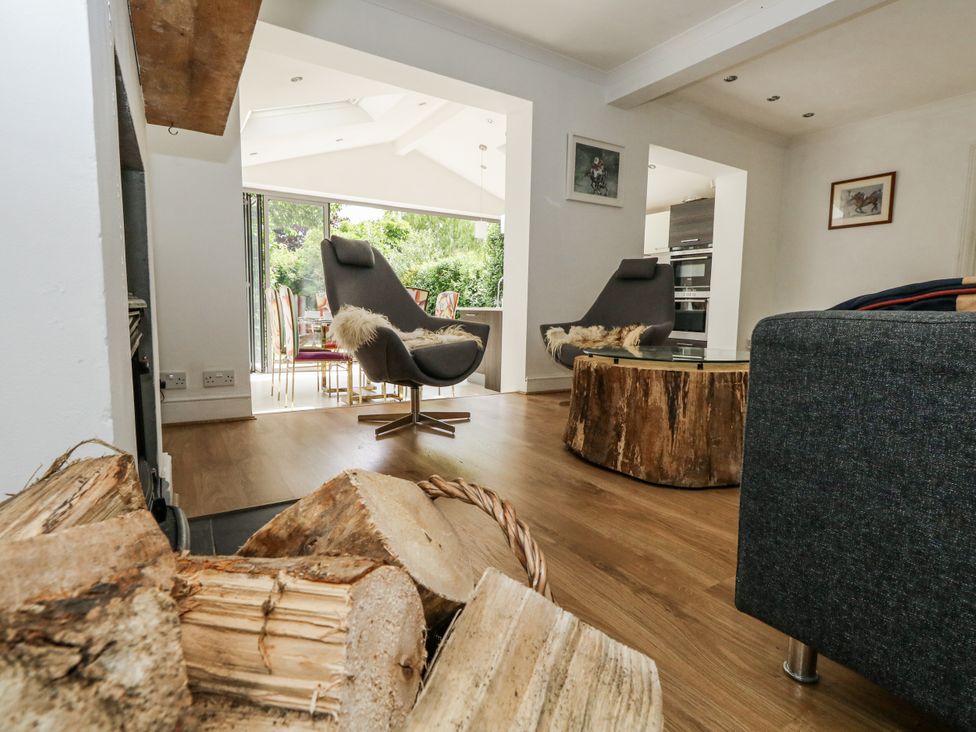 A living room with a coffee table and armchair at King Henry House in Lymington