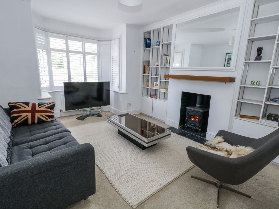 A living room with a sofa and television at King Henry House in Lymington