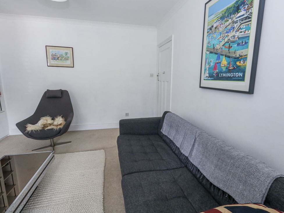 A living room with a sofa and an armchair at King Henry House in Lymington