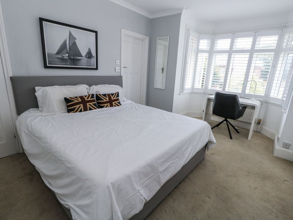 A bedroom with a bed and desk at King Henry House in Lymington