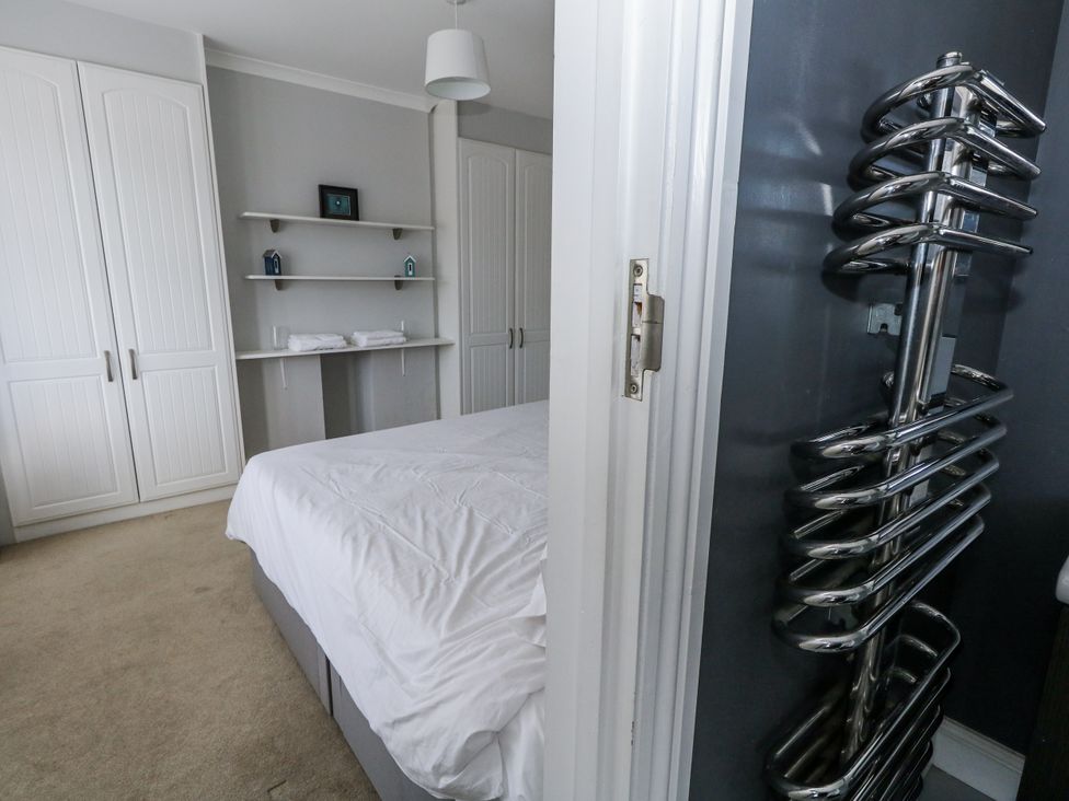 A bedroom with a bed and wardrobe at King Henry House in Lymington