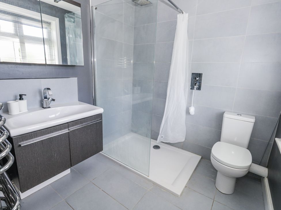 A bathroom with a shower and toilet at King Henry House in Lymington