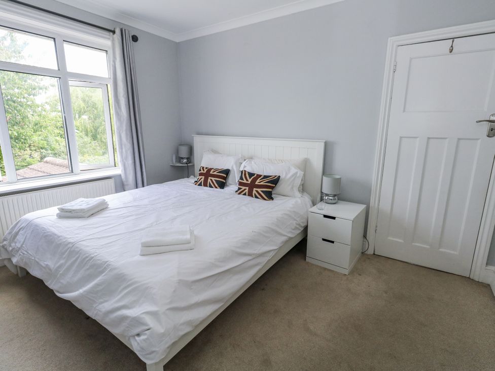 A bedroom with a bed and nightstand at King Henry House in Lymington