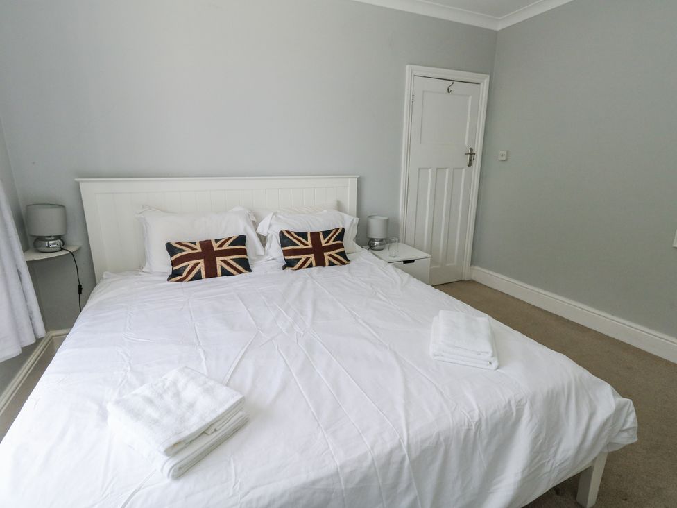 A bedroom with a bed and nightstand at King Henry House in Lymington
