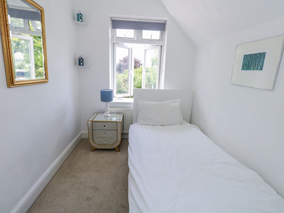 A bedroom with a single bed and a nightstand at King Henry House in Lymington