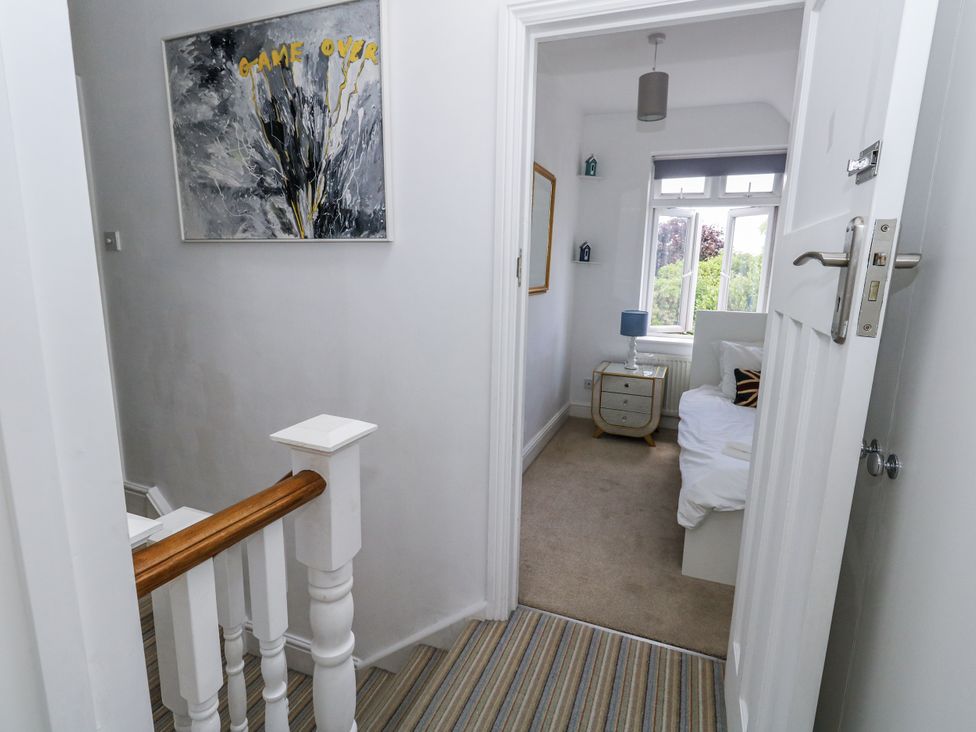 A bedroom with a bed and window at King Henry House in Lymington