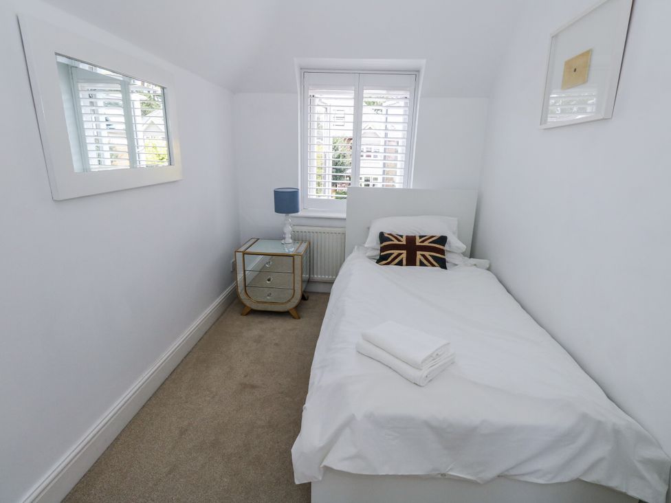A bedroom with a single bed and a bedside table at King Henry House in Lymington