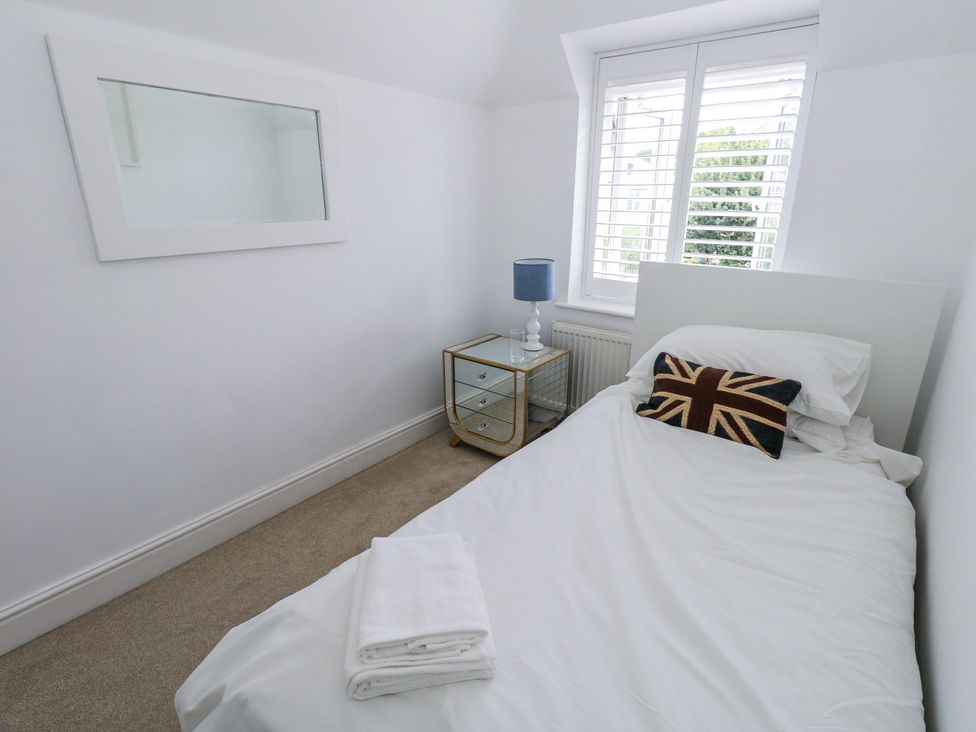 A bedroom with a bed and bedside table at King Henry House in Lymington