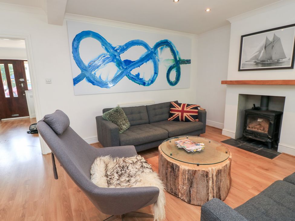 A living room with a sofa, armchair, and coffee table at King Henry House in Lymington