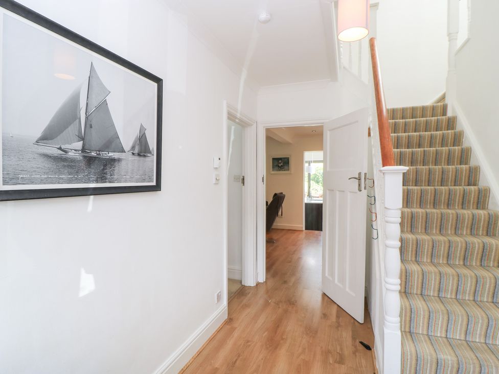 A hallway with a staircase and door at King Henry House in Lymington