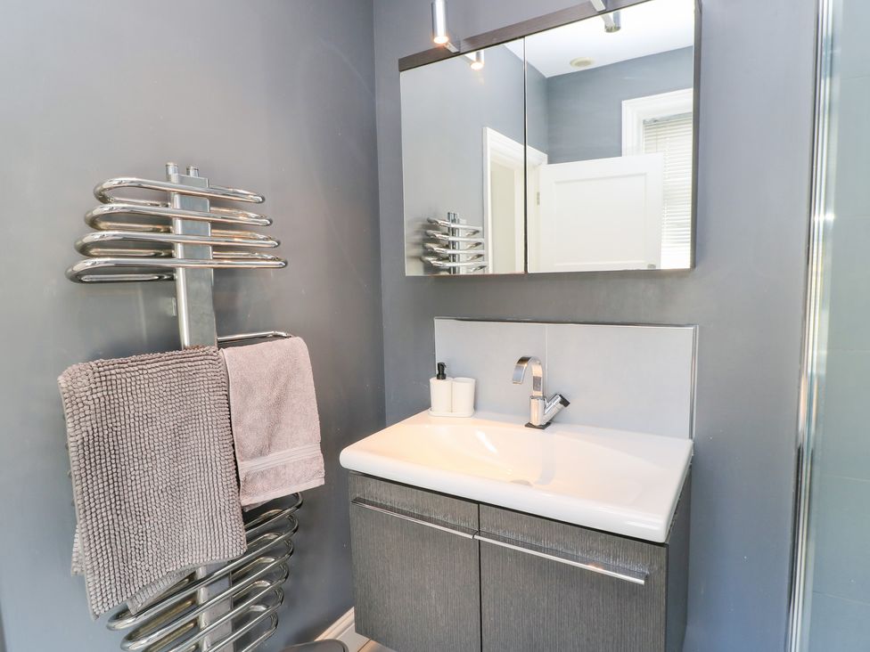 A bathroom with a sink and towel radiator at King Henry House Lymington