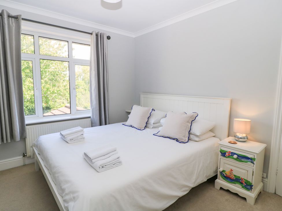 A bedroom with a double bed and a window at King Henry House in Lymington