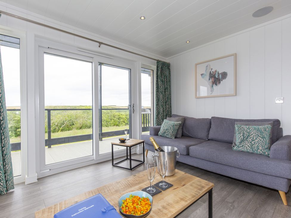 A living room with a sofa and a coffee table at Dahlia in Portreath