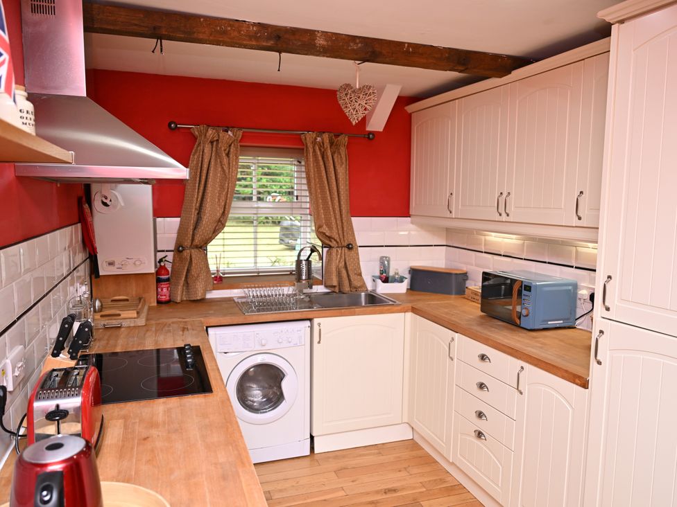 A kitchen with appliances and wooden countertops at Petty Knowes Cottage, Rochester near Otterburn