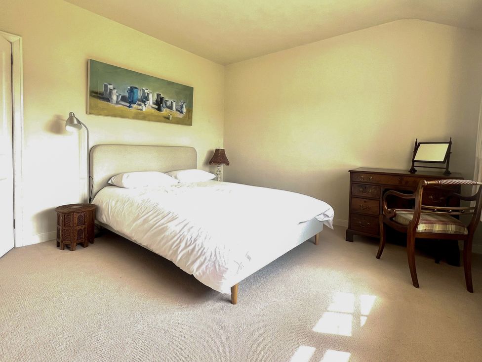 A bedroom with a bed and dresser at Higher Park Farm in Alderley Edge