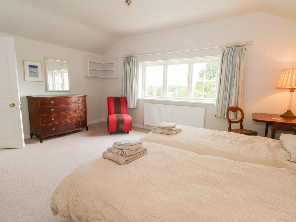 A bedroom with beds and a chest of drawers at Higher Park Farm Alderley Edge