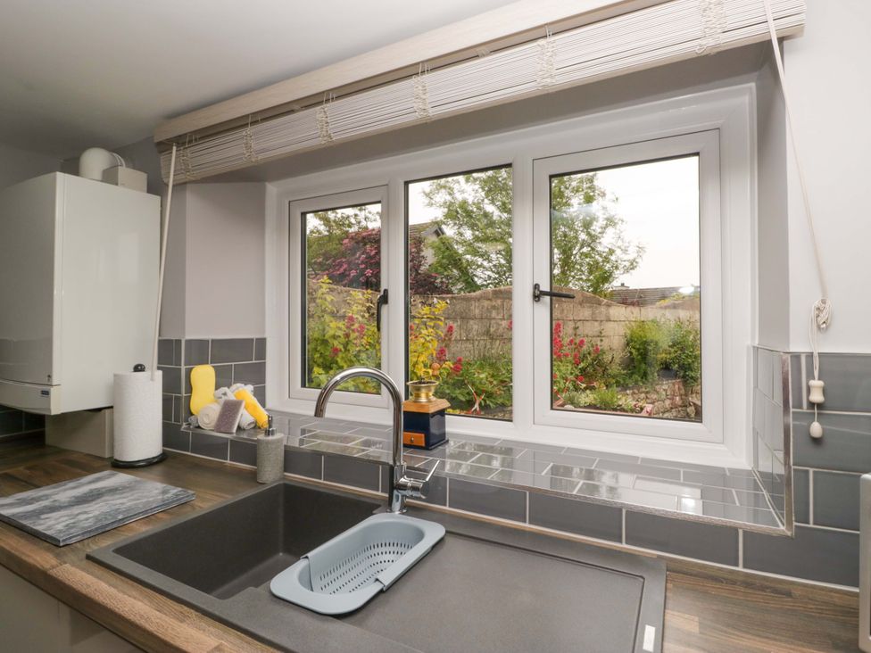 A kitchen featuring a sink and window at Yeat Stoup Cottage Cockermouth
