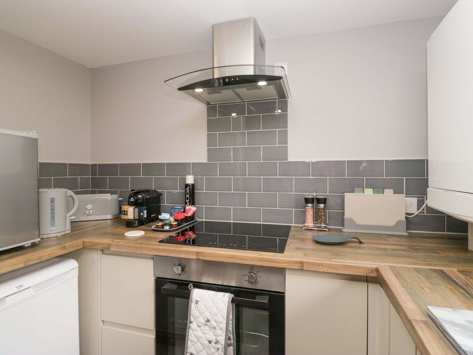 A kitchen with appliances and cooking space at Yeat Stoup Cottage in Cockermouth