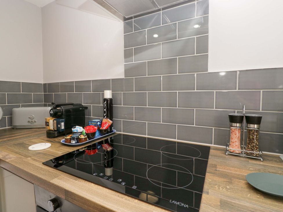 A kitchen with an induction hob and coffee machine at Yeat Stoup Cottage, Cockermouth