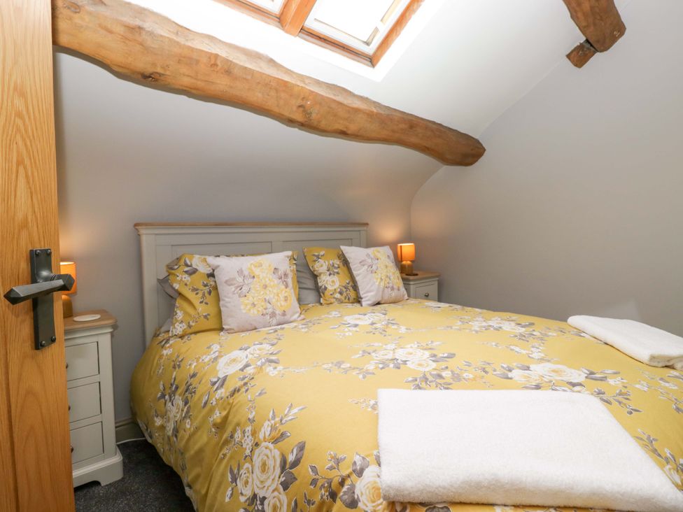 A bedroom with a bed and skylight at Yeat Stoup Cottage in Cockermouth
