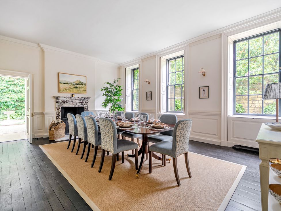 A dining room with a table set for dinner at Batheaston House in Batheaston
