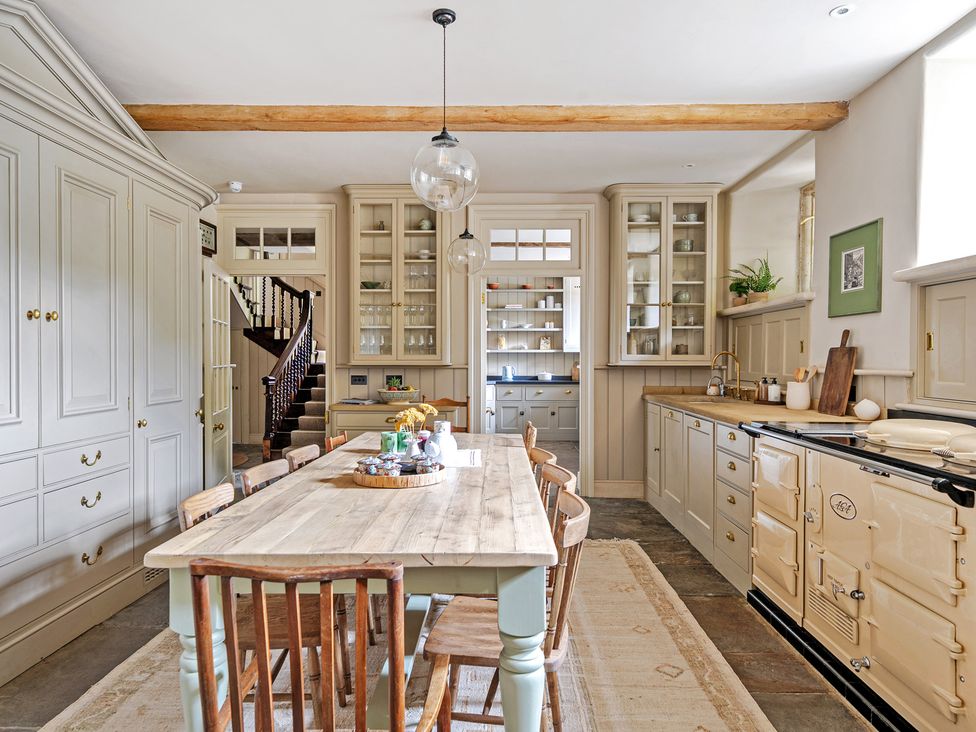 A kitchen with a dining table and chairs at Batheaston House in Batheaston